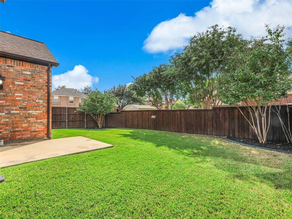 3504 Anita Drive, McKinney, TX 75070 Backyard featuring a concrete patio, brick exterior wall, manicured lawn, and full-height wood privacy fencing