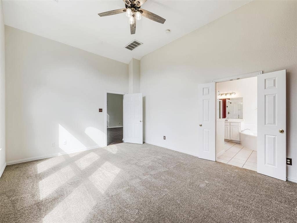 3504 Anita Drive, McKinney, TX 75070 Vaulted ceilings featuring a central multi-blade ceiling fan, wall-to-wall carpeting, and double-door entry