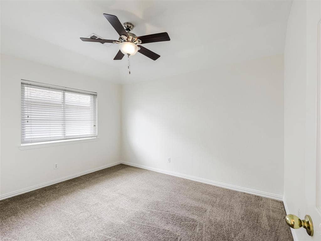 3504 Anita Drive, McKinney, TX 75070 Neutral-toned wall-to-wall carpeting, window with integrated blinds, and ceiling fan with central light fixture