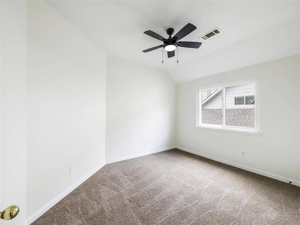 3504 Anita Drive, McKinney, TX 75070 Neutral-toned room featuring a vaulted ceiling, plush wall-to-wall carpeting, and a central ceiling fan with an integrated light fixture
