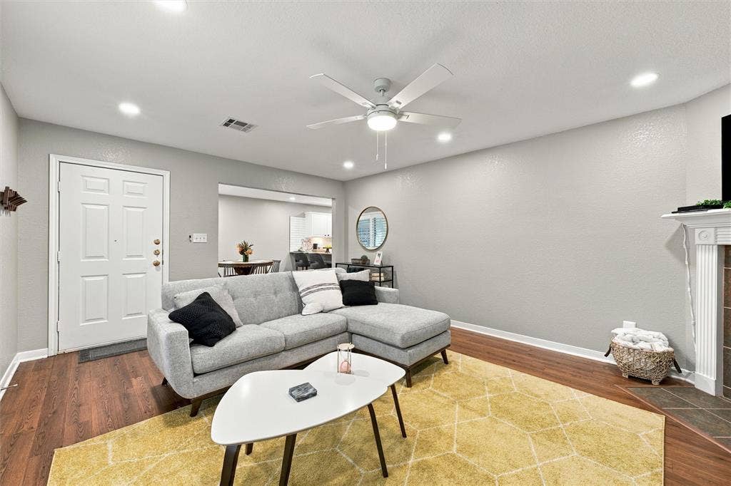 813 Chambers Creek Circle, Hewitt, TX 76643 Living area featuring wood-finish flooring, recessed lighting, a ceiling fan with integrated lighting, and a fireplace with a decorative mantel