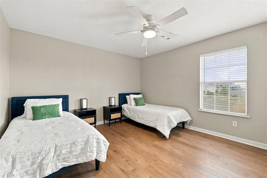 813 Chambers Creek Circle, Hewitt, TX 76643 Neutral wall tones, wood-finish flooring, ceiling fan with integrated light fixture, and horizontal blind window treatment