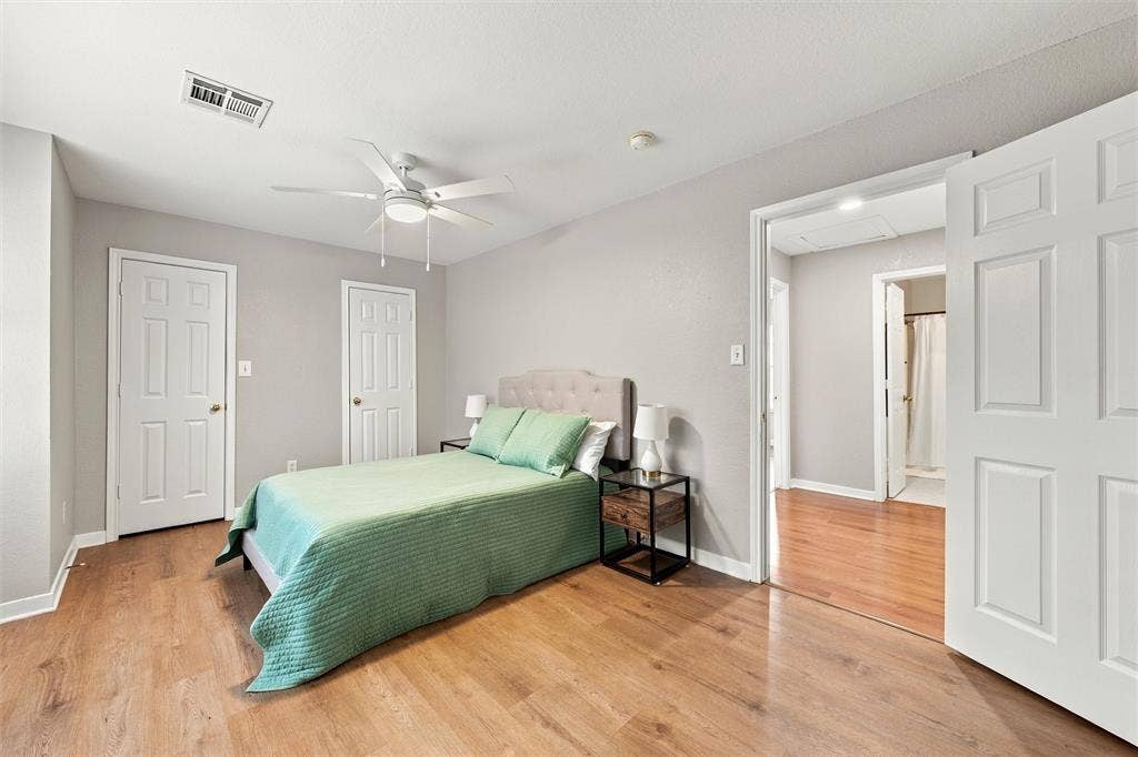 813 Chambers Creek Circle, Hewitt, TX 76643 Room featuring wood-finish flooring, a white ceiling fan with integrated lighting, and multiple interior doors with white finish