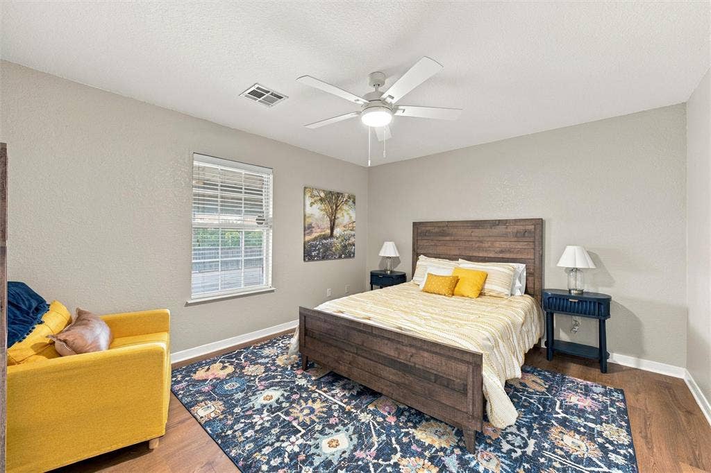 813 Chambers Creek Circle, Hewitt, TX 76643 Room featuring wood-finish flooring, a neutral paint palette, and a white ceiling fan with integrated lighting