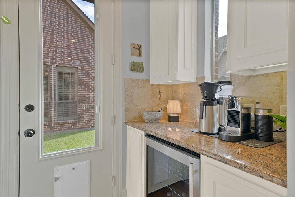 2141 Waterrock Drive, Allen, TX 75013 Custom cabinetry, stone-finish countertops, stone tile backsplash, and built-in under-counter beverage refrigerator