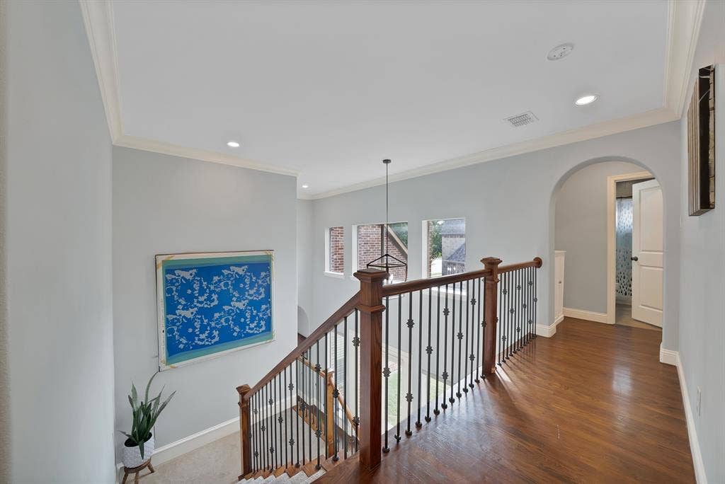 2141 Waterrock Drive, Allen, TX 75013 Upper landing featuring wood-finish flooring, a decorative metal baluster railing, recessed lighting, and a prominent arched entryway