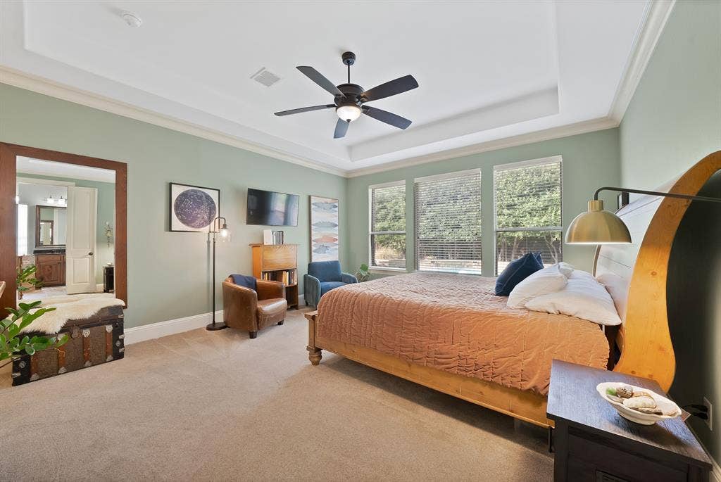 2141 Waterrock Drive, Allen, TX 75013 Tray ceiling with crown molding, ceiling fan, carpeting, and multiple windows