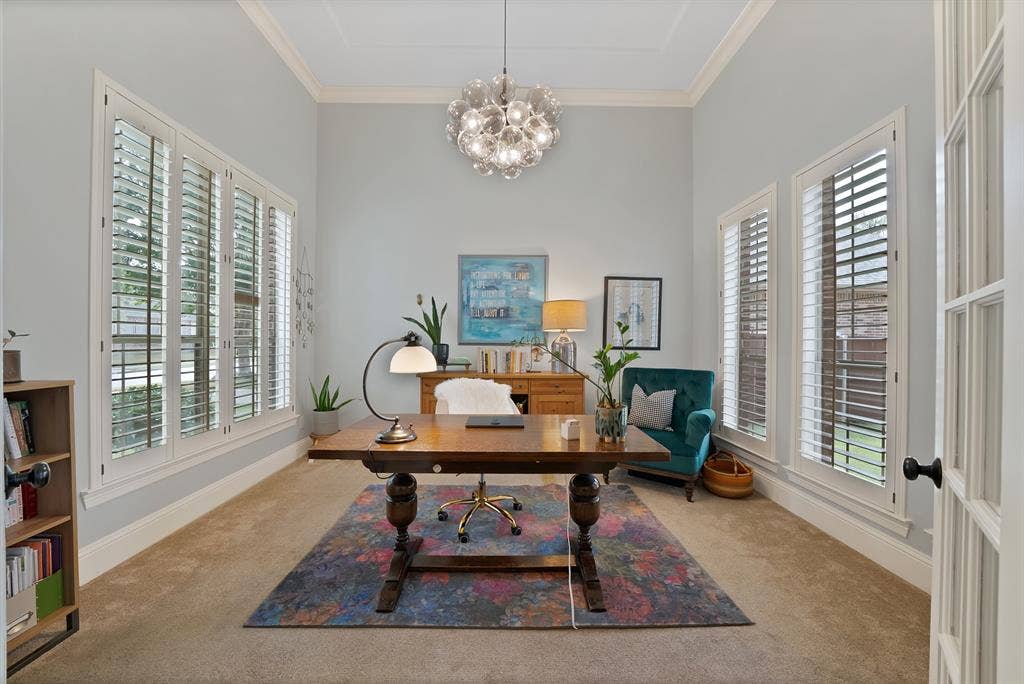 2141 Waterrock Drive, Allen, TX 75013 High-ceilinged room featuring crown molding, multiple windows with plantation shutters, and a multi-sphere glass pendant light fixture