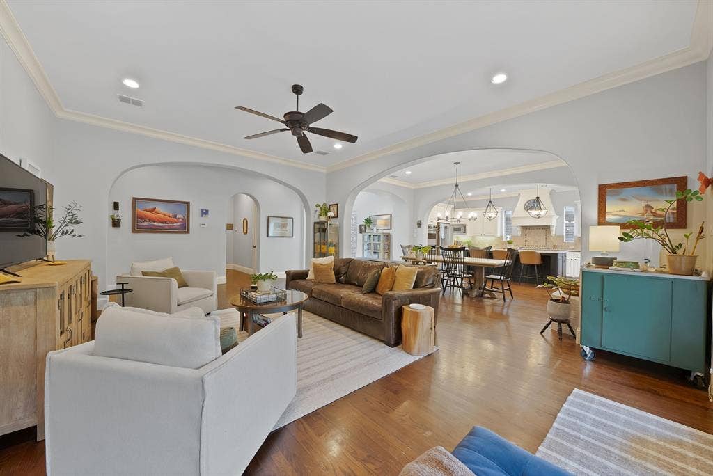 2141 Waterrock Drive, Allen, TX 75013 Open-concept living space featuring wood-finish flooring, recessed lighting, crown molding, arched entryways, and a ceiling fan