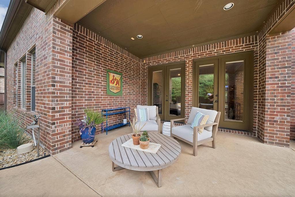 2141 Waterrock Drive, Allen, TX 75013 Covered patio featuring red brick masonry, a solid-surface floor, recessed lighting, and dual glass-paneled exterior doors