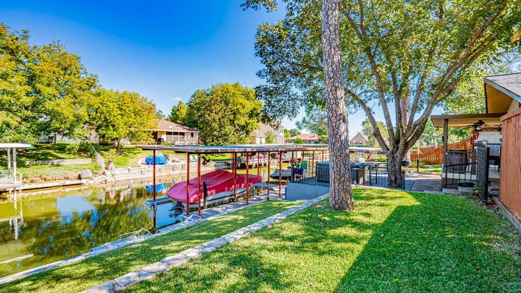 4015 Sioux Court, Granbury, TX 76048 Boat dock with a lift and a double Sea Doo lift. Flagstone walkway to boat dock. Large jacuzzi hot tub on the Trex deck