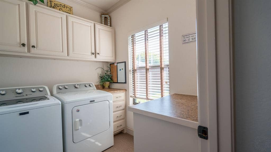 4015 Sioux Court, Granbury, TX 76048 Laundry room with conveying washer and dryer and good storage space