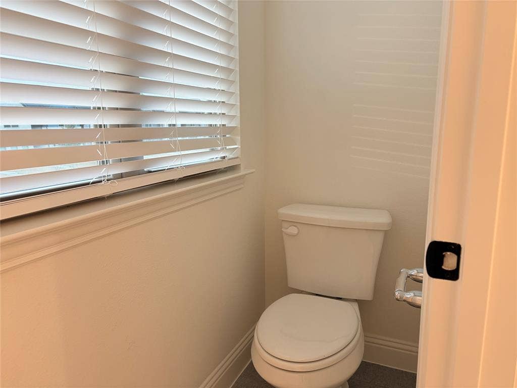 2528 Brunswick Way, Allen, TX 75013 Water closet featuring a two-piece toilet, horizontal window blinds, and solid-surface flooring