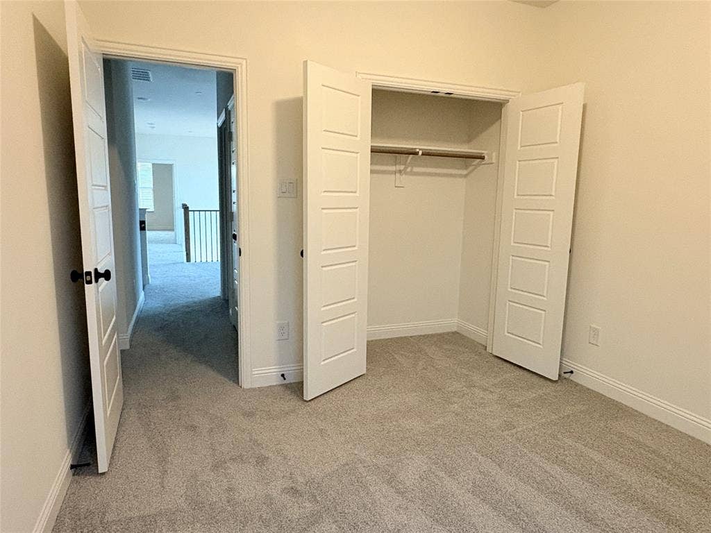 2528 Brunswick Way, Allen, TX 75013 Neutral interior featuring wall-to-wall carpeting, five-panel interior doors, and a built-in closet with overhead hanging rod
