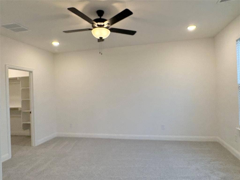 2528 Brunswick Way, Allen, TX 75013 Neutral-toned carpeted flooring, multi-blade ceiling fan with integrated lighting, recessed ceiling lights, and walk-in storage area with built-in shelving
