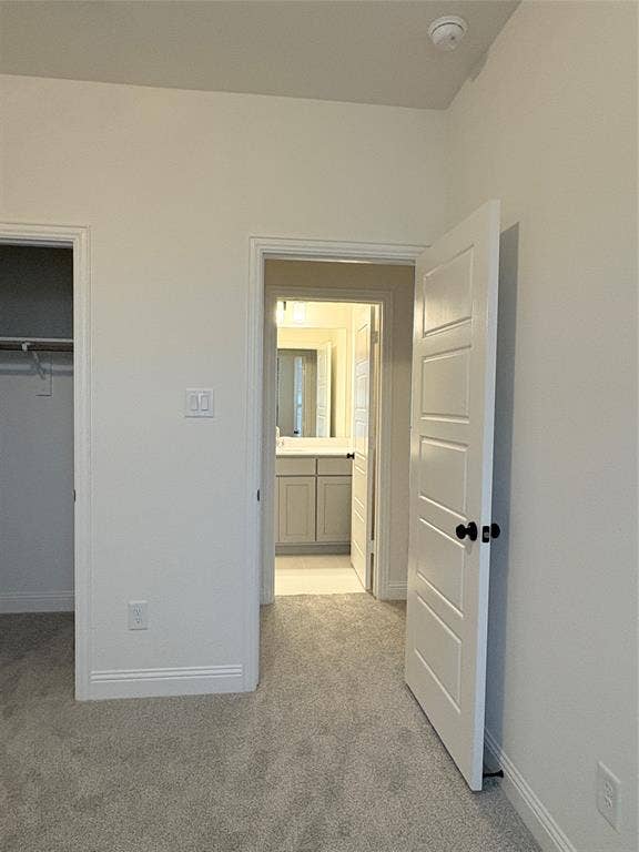 2528 Brunswick Way, Allen, TX 75013 Four-panel interior door with matte black hardware, neutral wall-to-wall carpeting, and neutral wall palette