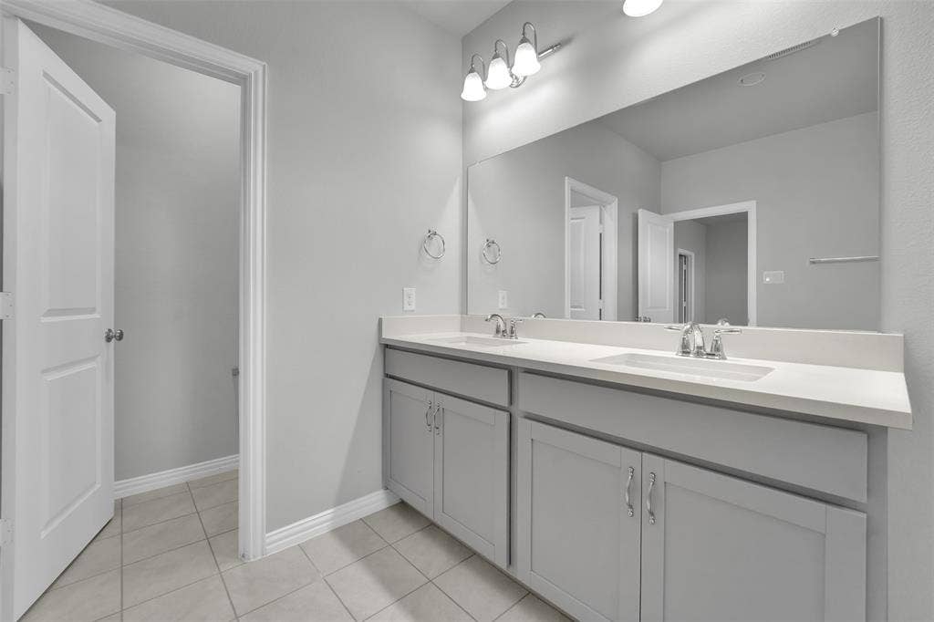 Dual vanity with white countertops and undermount sinks