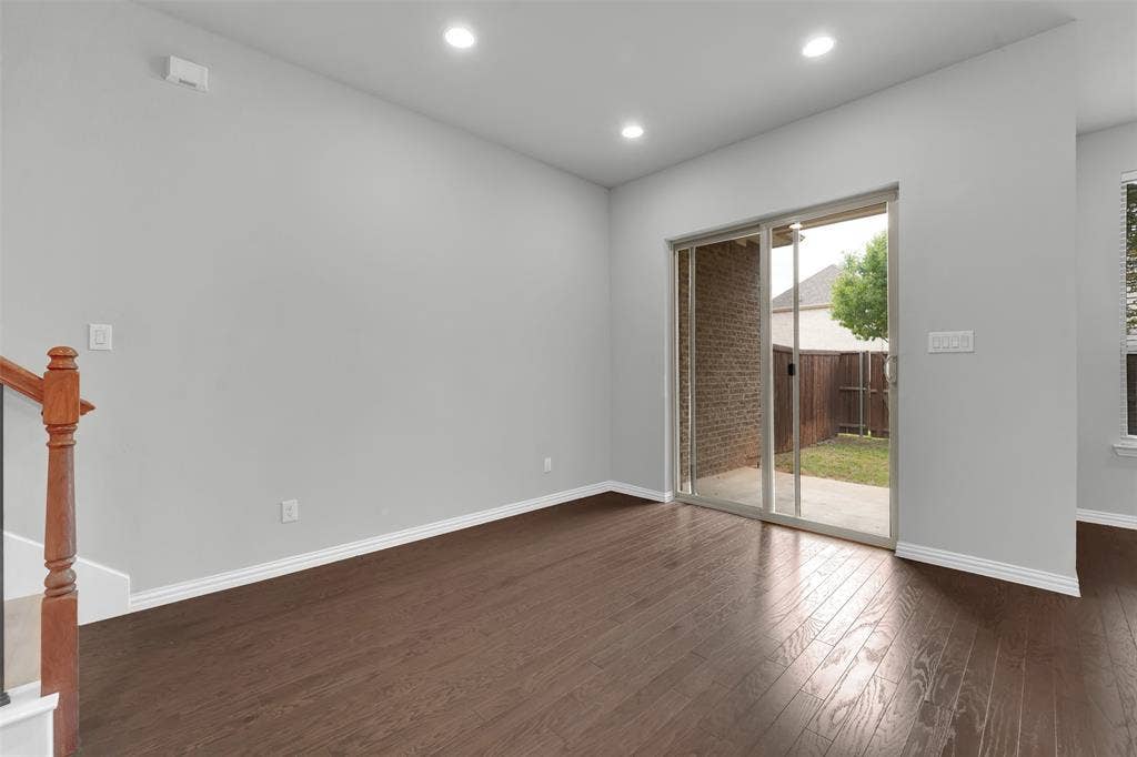 Wood-finish flooring, recessed lighting, and a sliding glass door