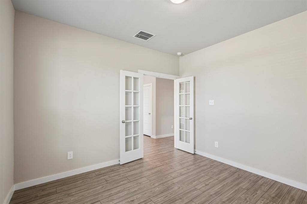 135 Lost Maples Way, Waxahachie, TX 75165 Room featuring wood-finish flooring and double French doors with glass panes