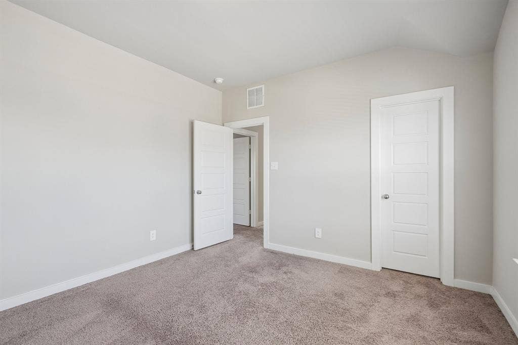 135 Lost Maples Way, Waxahachie, TX 75165 Interior room featuring neutral-toned carpeting, high ceilings, and white four-panel interior doors