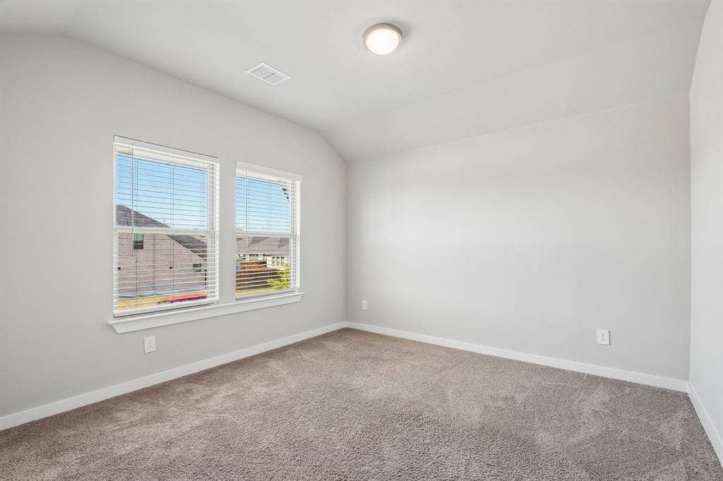 135 Lost Maples Way, Waxahachie, TX 75165 Neutral-toned interior room featuring wall-to-wall carpeting, vaulted ceilings, and dual windows with fitted blinds