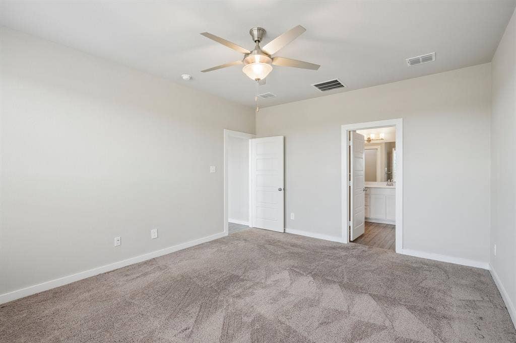 135 Lost Maples Way, Waxahachie, TX 75165 Neutral-toned interior featuring wall-to-wall carpeting, a ceiling fan with integrated light fixture, and white-paneled interior doors