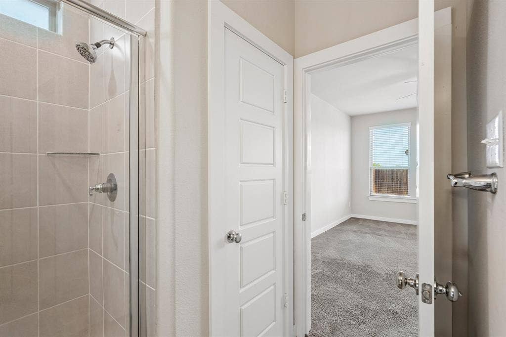 135 Lost Maples Way, Waxahachie, TX 75165 Tiled walk-in shower with a glass enclosure, five-panel door, and wall-to-wall carpeting