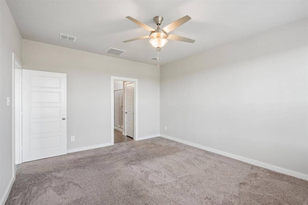 135 Lost Maples Way, Waxahachie, TX 75165 Room featuring neutral-toned carpeting, high ceilings, a multi-blade ceiling fan with an integrated light fixture, and two five-panel interior doors