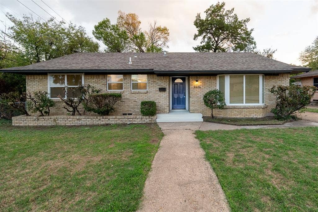 2406 Cliff Teen Court, Dallas, TX 75233 Single-story brick exterior featuring a low-pitched roof, central entryway, multi-pane windows, and a built-in front garden bed