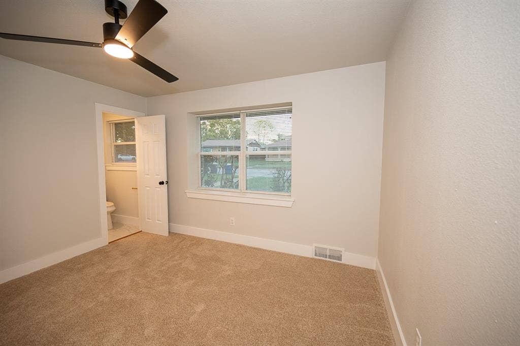 2406 Cliff Teen Court, Dallas, TX 75233 Room featuring neutral carpeting, matte black ceiling fan with integrated lighting, and a multi-pane window