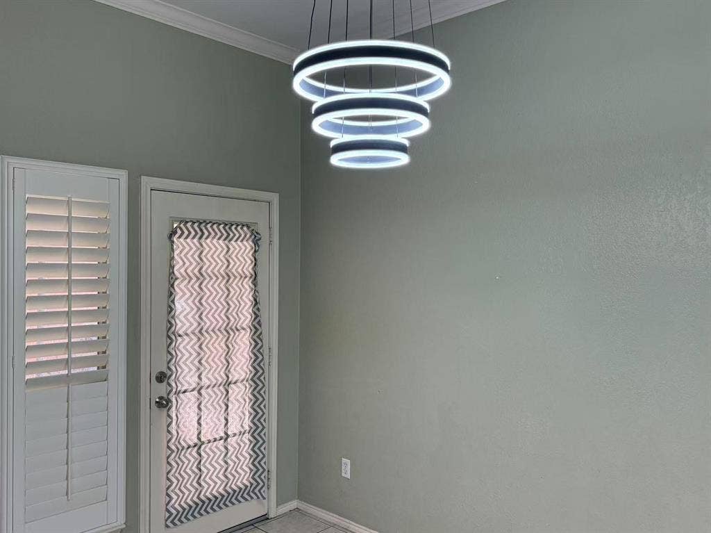 1307 Capstan Drive, Allen, TX 75013 Multi-tiered LED ring chandelier, white louvered plantation shutters, and glass-paneled exterior door