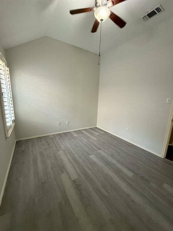 1307 Capstan Drive, Allen, TX 75013 Vaulted ceiling featuring a central wooden-blade ceiling fan, shutter-style window coverings, and neutral wood-finish flooring