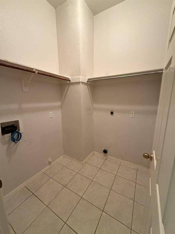 1307 Capstan Drive, Allen, TX 75013 Utility area featuring ceramic tile flooring, built-in shelving, and dedicated washer and dryer hookups