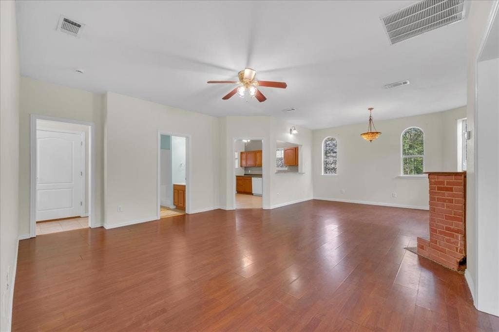 View of back unit upon entrance. Full bath on level 1, flex space, washer and dryer hookups, kitchen and access to the backyard.