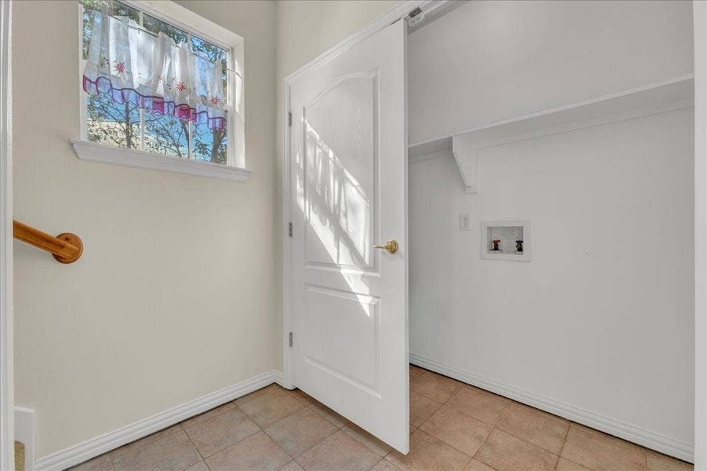 Laundry hookup at the bottom of stairs in back unit.