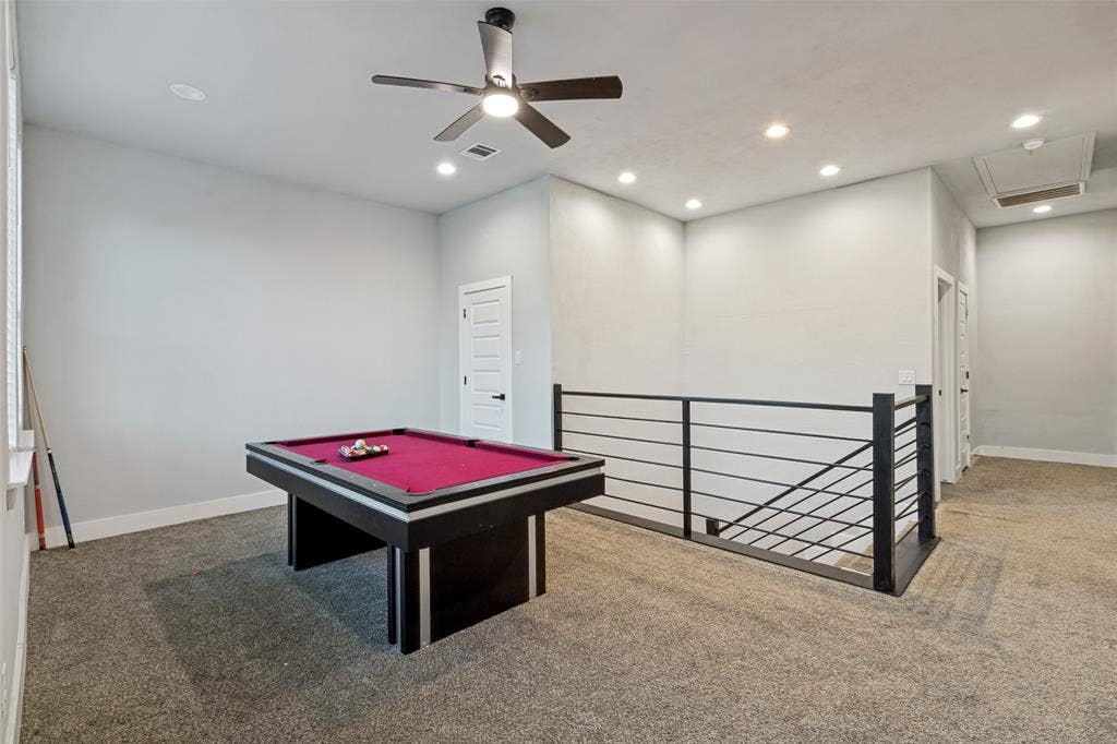 7909 Ivory Lane, Dallas, TX 75216 Interior space featuring neutral-toned carpeting, recessed lighting, a modern ceiling fan, and a metal horizontal-bar stair railing