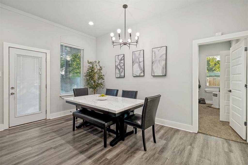 7909 Ivory Lane, Dallas, TX 75216 Room featuring wood-finish flooring, a multi-arm chandelier, recessed lighting, and a door with an inset glass pane
