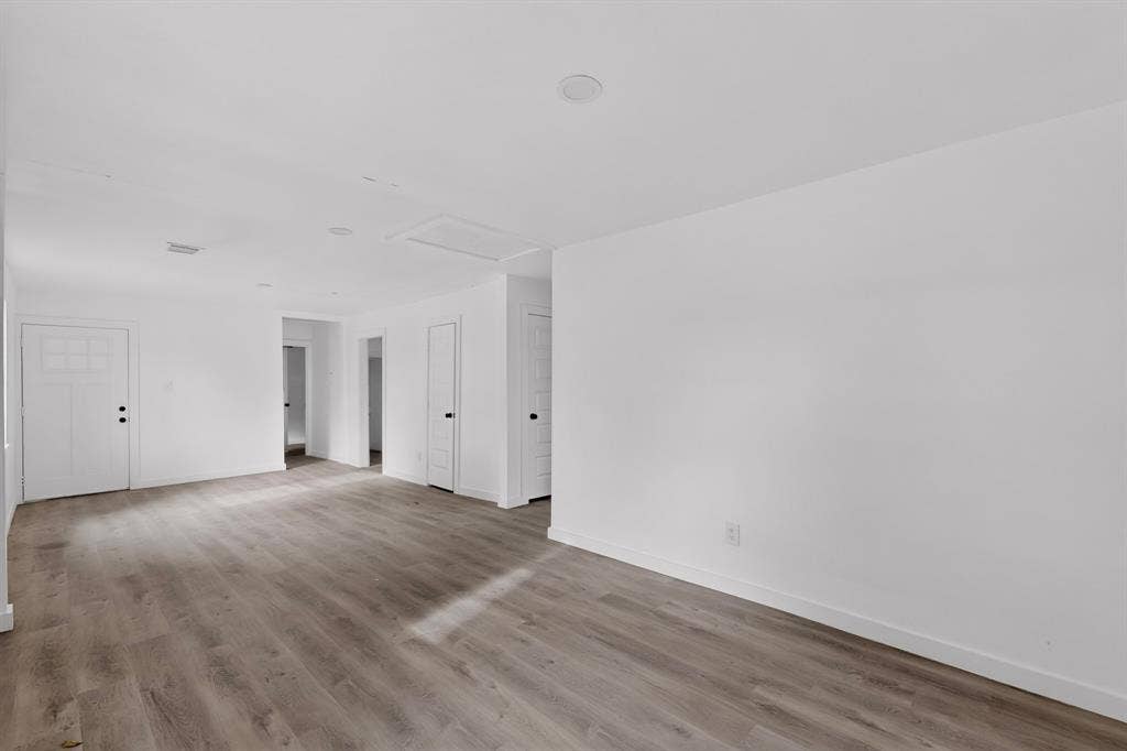1831 Highland Street, Mesquite, TX 75149 Neutral interior space featuring wood-finish flooring, recessed lighting, and multi-panel interior doors
