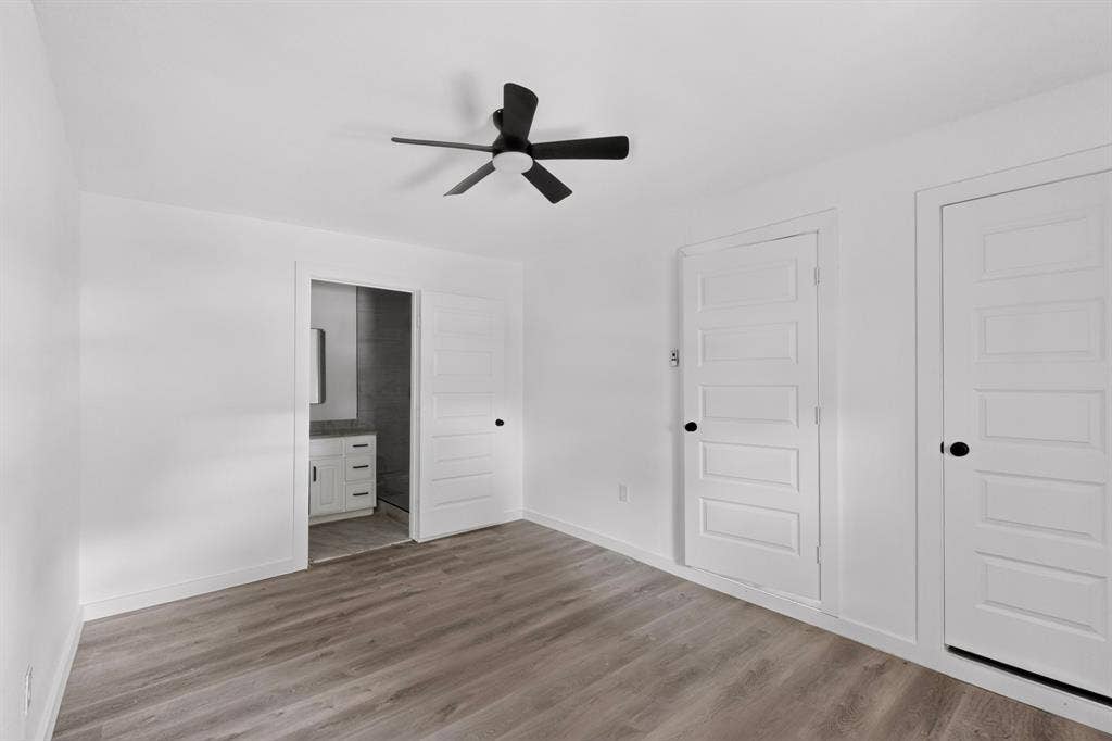 1831 Highland Street, Mesquite, TX 75149 Interior space featuring wood-finish flooring, a matte black ceiling fan, and three-panel interior doors with matte black hardware