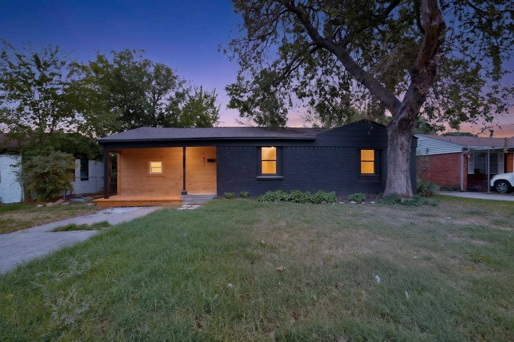 1831 Highland Street, Mesquite, TX 75149 Single-story residence featuring a painted brick exterior, natural wood-paneled porch, covered entry, and mature landscaping