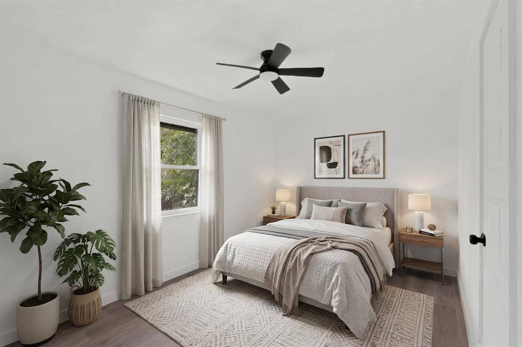 1831 Highland Street, Mesquite, TX 75149 Room featuring wood-finish flooring, a matte black ceiling fan with integrated lighting, and a window with neutral-toned hardware