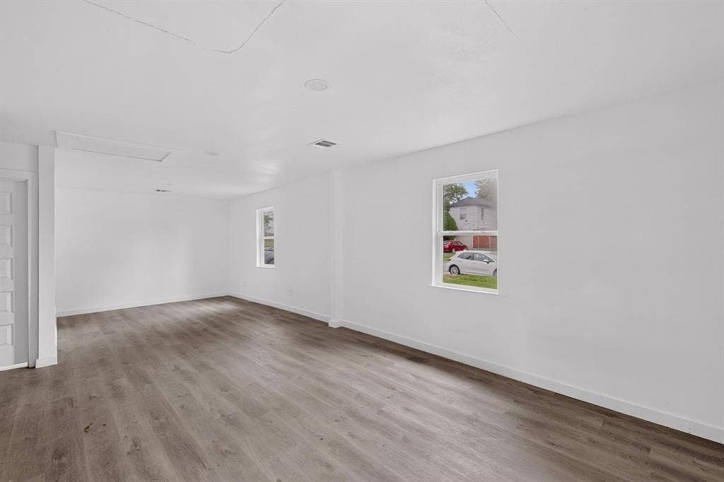 1831 Highland Street, Mesquite, TX 75149 Neutral interior featuring wood-finish flooring, white walls, and multiple single-hung windows