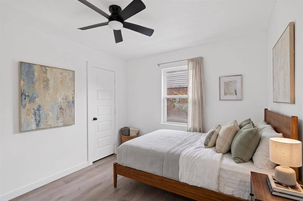 1831 Highland Street, Mesquite, TX 75149 Interior space featuring wood-finish flooring, a five-panel interior door, and a matte black ceiling fan with an integrated light fixture