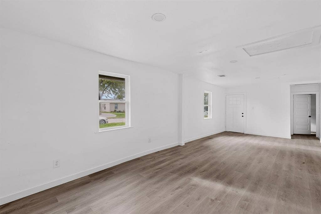 1831 Highland Street, Mesquite, TX 75149 Interior space featuring wood-finish flooring, recessed lighting, white walls, and multiple single-hung windows