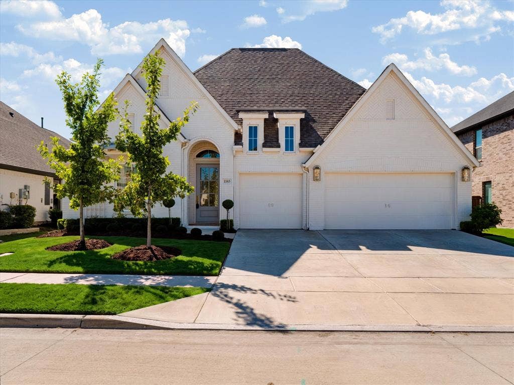 1103 Sandgate Drive, Forney, TX 75126 Brick exterior with a gabled roofline, arched entryway, and three-car garage