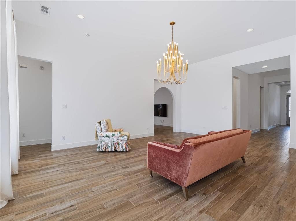 1103 Sandgate Drive, Forney, TX 75126 High ceilings featuring recessed lighting, expansive wood-finish flooring, and an ornamental tiered metal chandelier