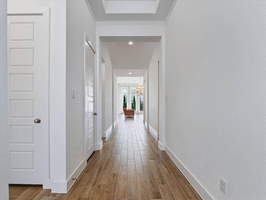 1103 Sandgate Drive, Forney, TX 75126 Hallway featuring wood-finish flooring, recessed lighting, a recessed ceiling detail, and five-panel interior doors