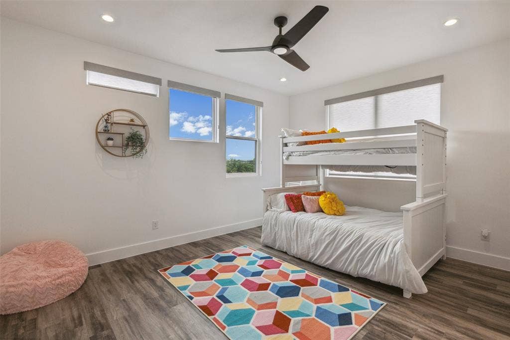 Bedroom featuring ceiling fan and dark hardwood / wood-style flooring