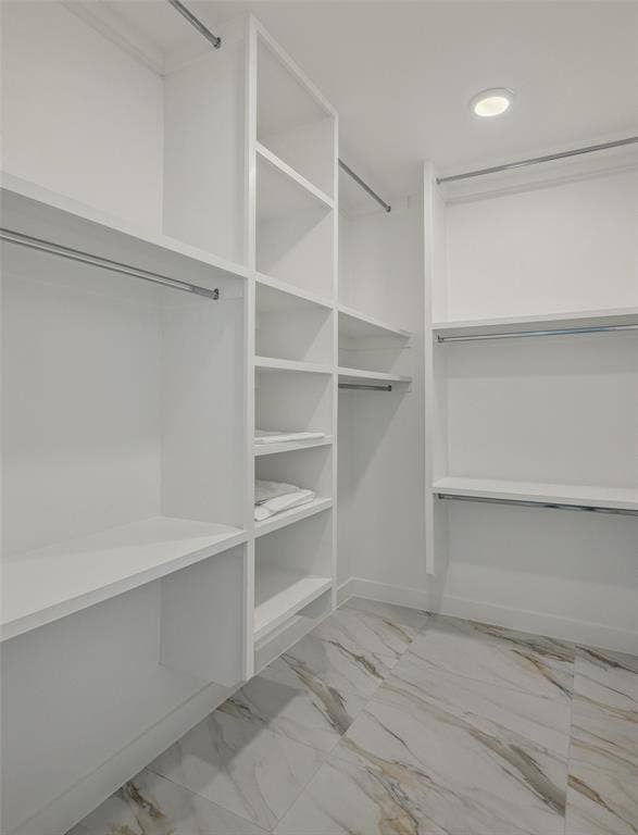 Spacious closet featuring light tile patterned flooring