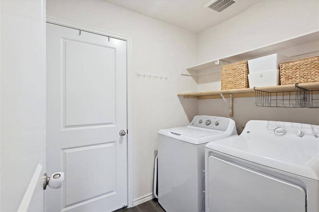 1108 Emerald Gate Drive, Princeton, TX 75407 Laundry area featuring a multi-panel door, built-in shelving, and wall-mounted garment hooks